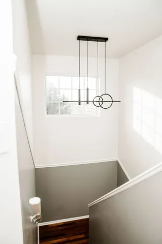 a view of a hallway with wooden floor and a potted plant