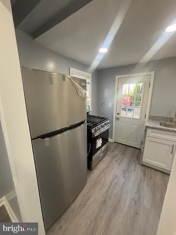 a kitchen with sink refrigerator and window