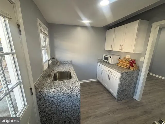 a kitchen with a refrigerator and a stove