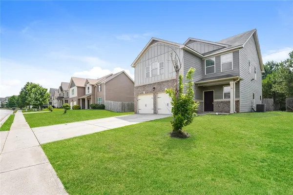an empty room with fireplace and windows