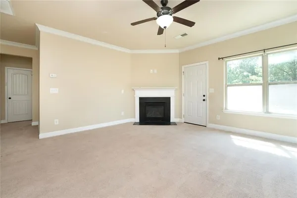 a view of a livingroom with a kitchen and a ceiling fan