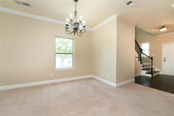 a kitchen with stainless steel appliances granite countertop a sink a stove and a wooden cabinets