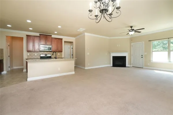 a kitchen with stainless steel appliances granite countertop a sink stove and cabinets