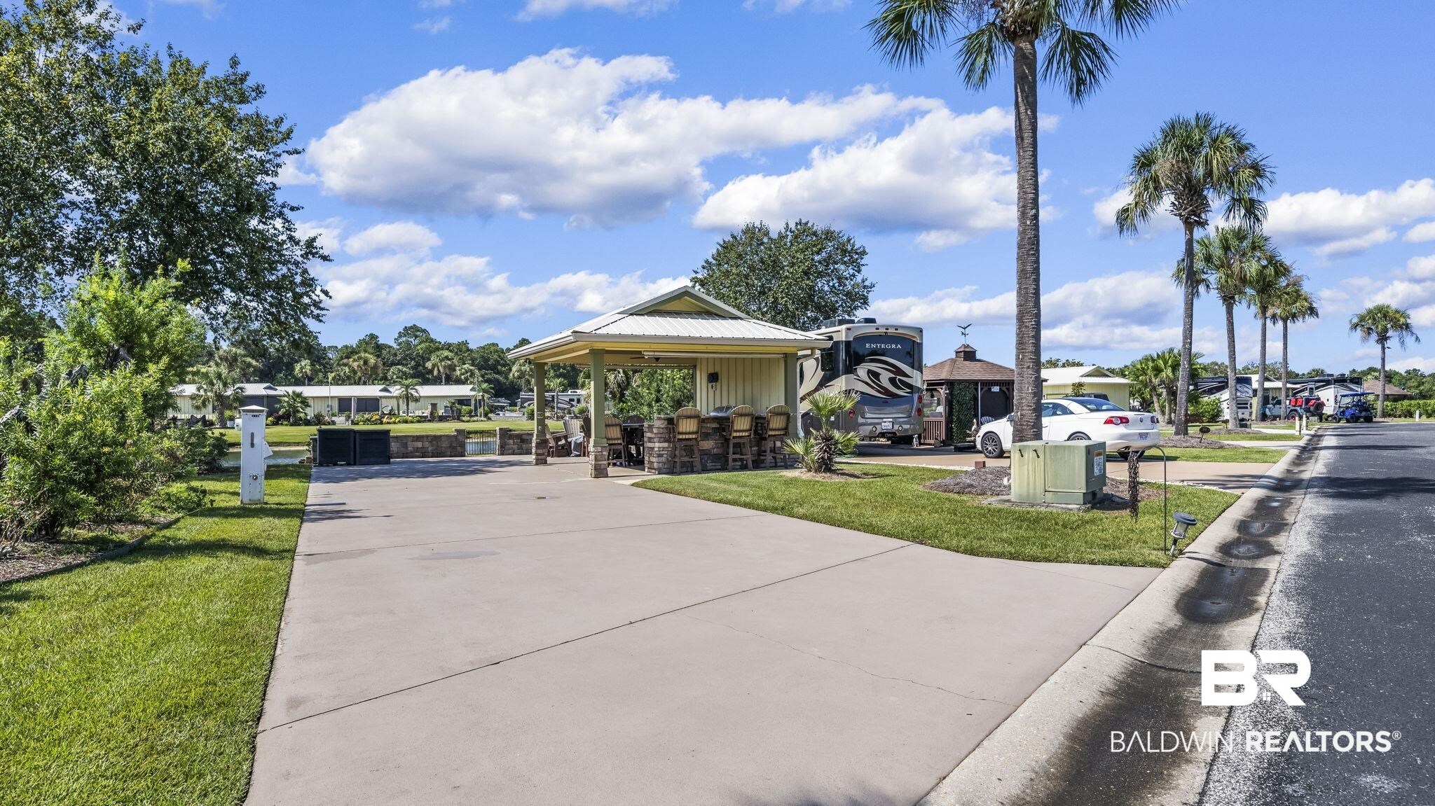 612 Sereno Street Foley, AL 36535 - Photo 5 of 48 View of property's community with a gazebo, a lawn, and driveway