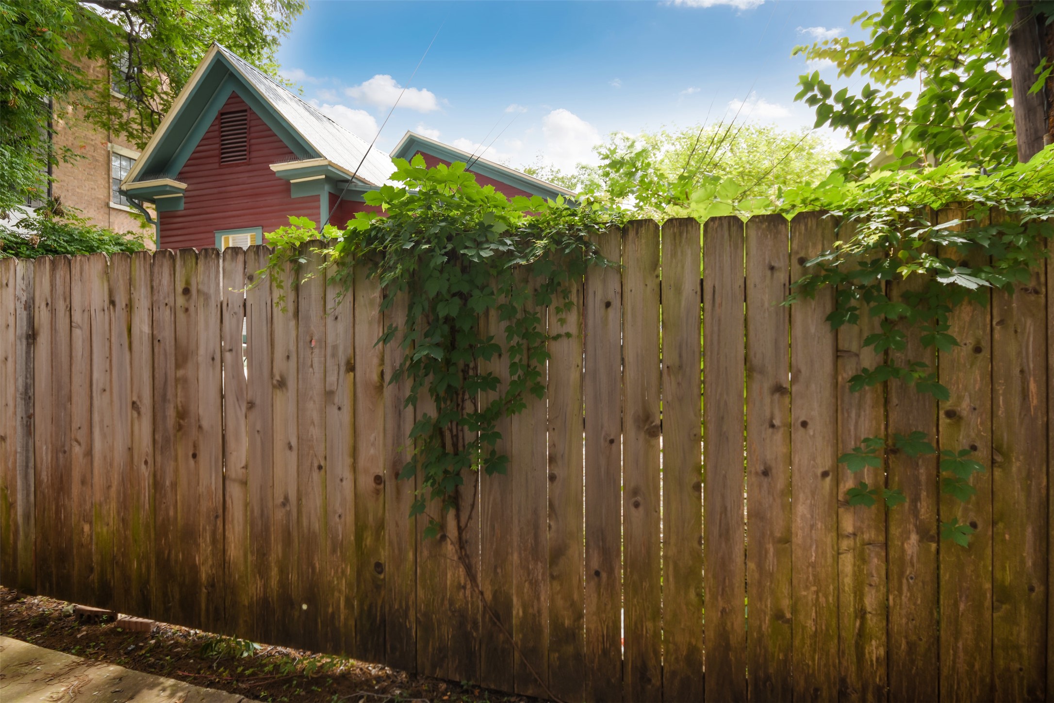 3004 Speedway, Unit 2 Austin, TX 78705 - Photo 19 of 20 a view of a house with a wooden fence next to a yard