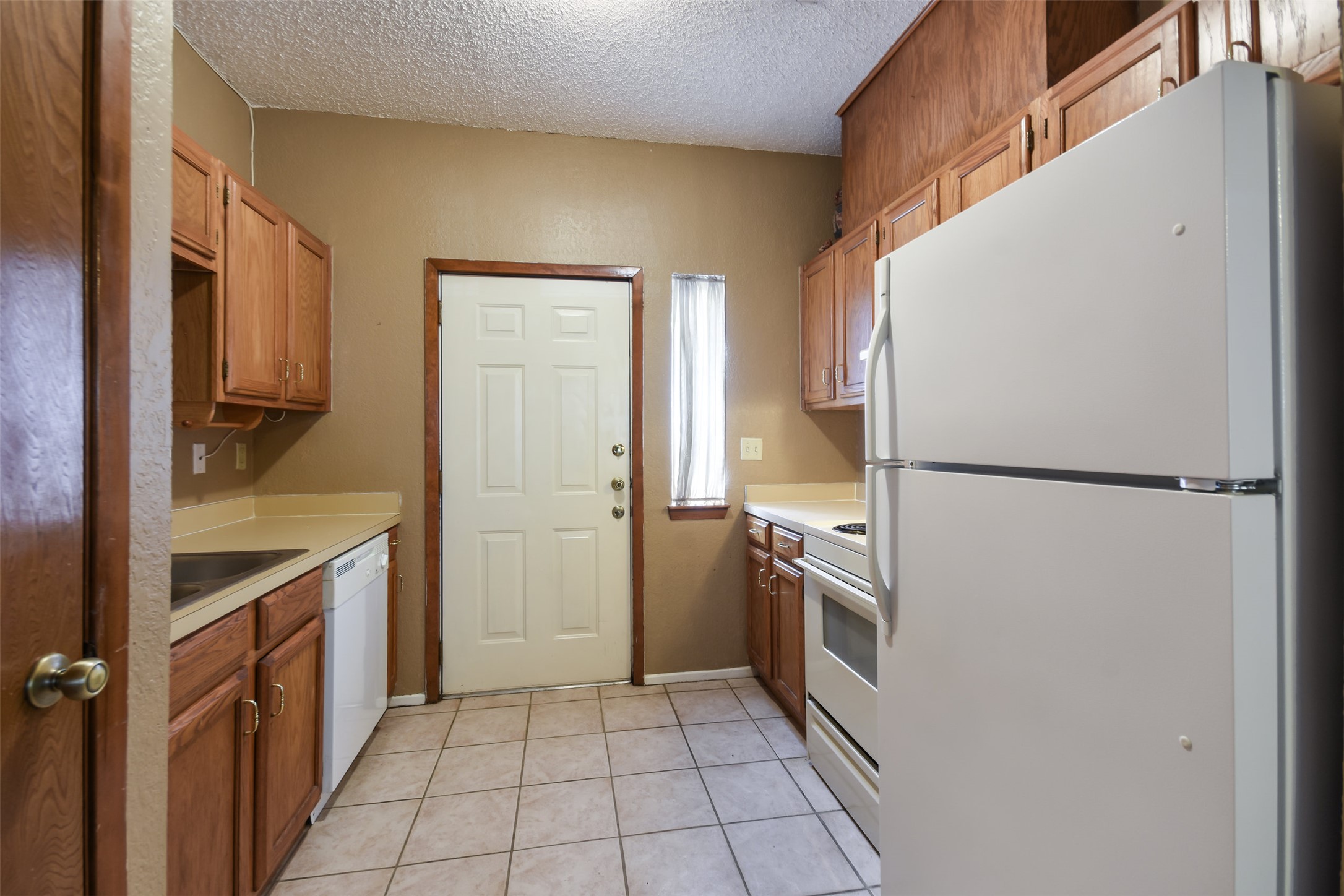 3004 Speedway, Unit 2 Austin, TX 78705 - Photo 9 of 20 a kitchen with a refrigerator and a sink