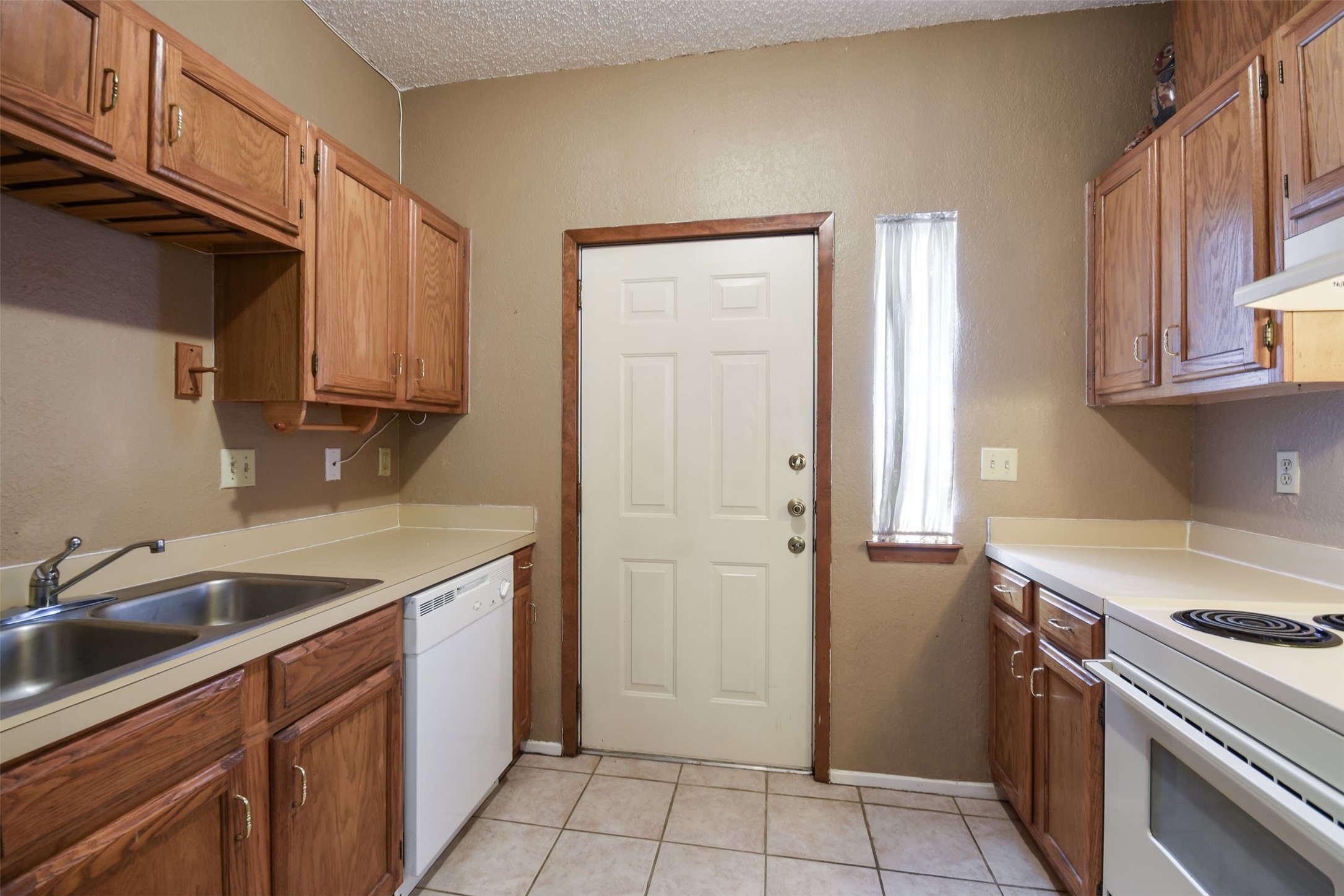 3004 Speedway, Unit 2 Austin, TX 78705 - Photo 10 of 20 a kitchen with a sink stove and cabinets