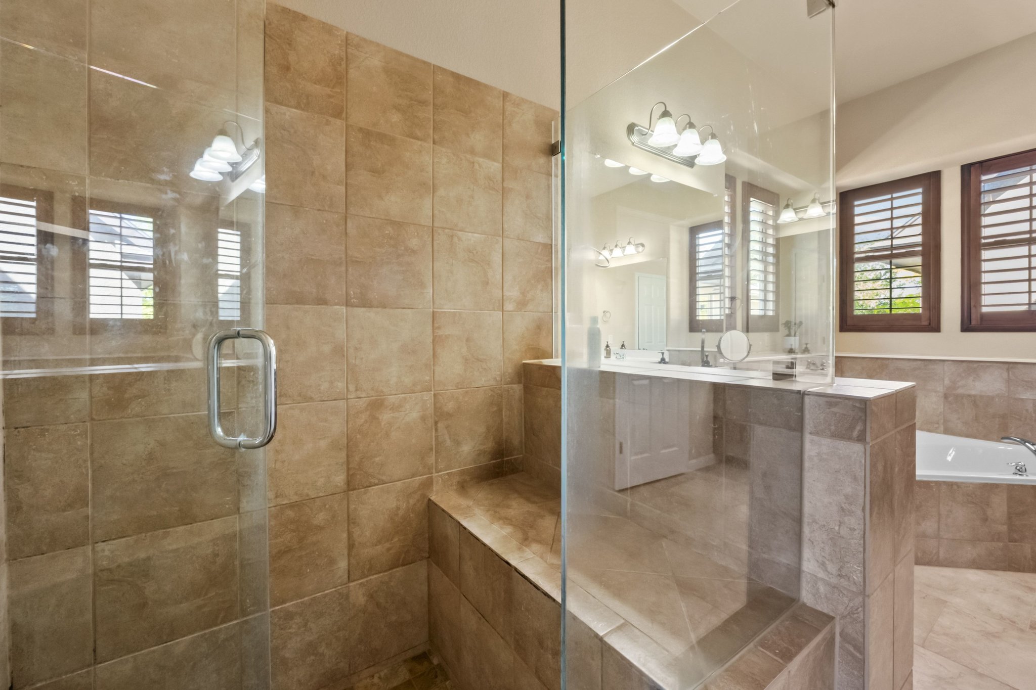 22204 Red Yucca Road Spicewood, TX 78669 - Photo 19 of 34 a bathroom with a granite countertop shower a mirror and a sink