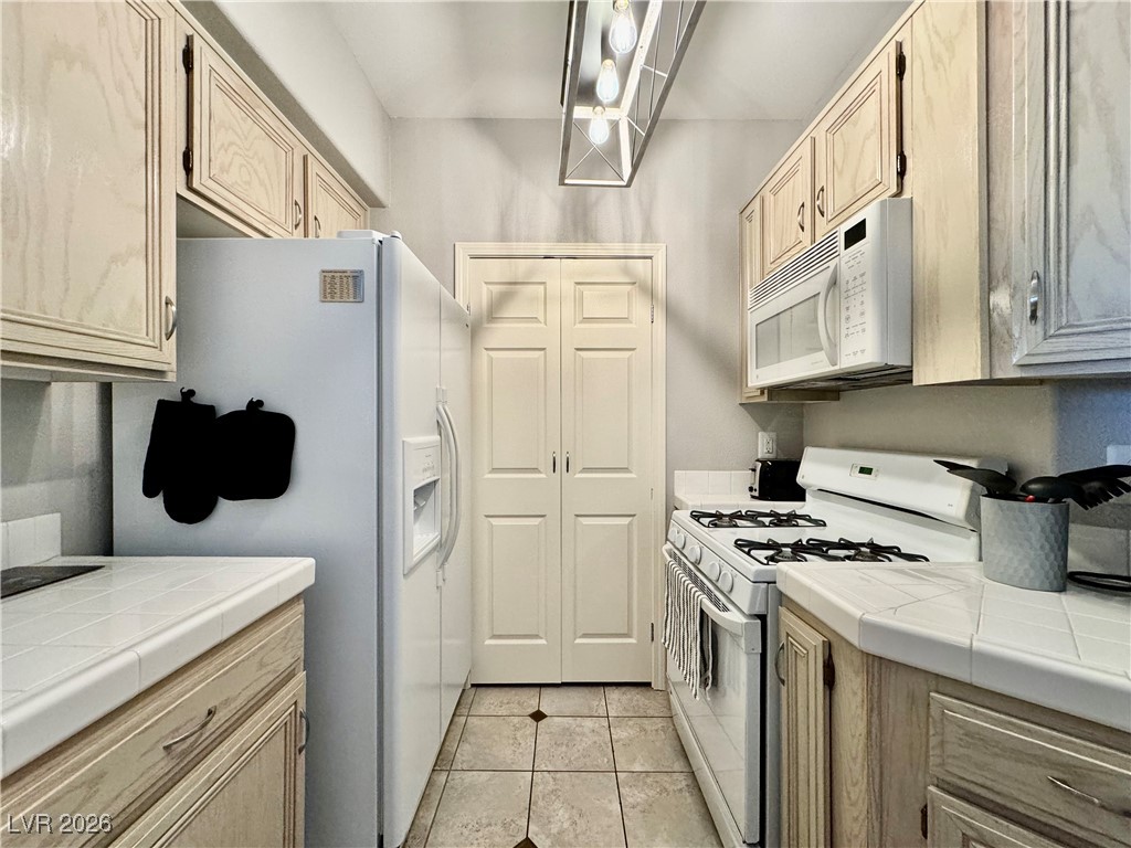 7151 South Durango Drive, Unit 307 Las Vegas, NV 89113 - Photo 5 of 17 kitchen with view of door leading to the Laundry Room