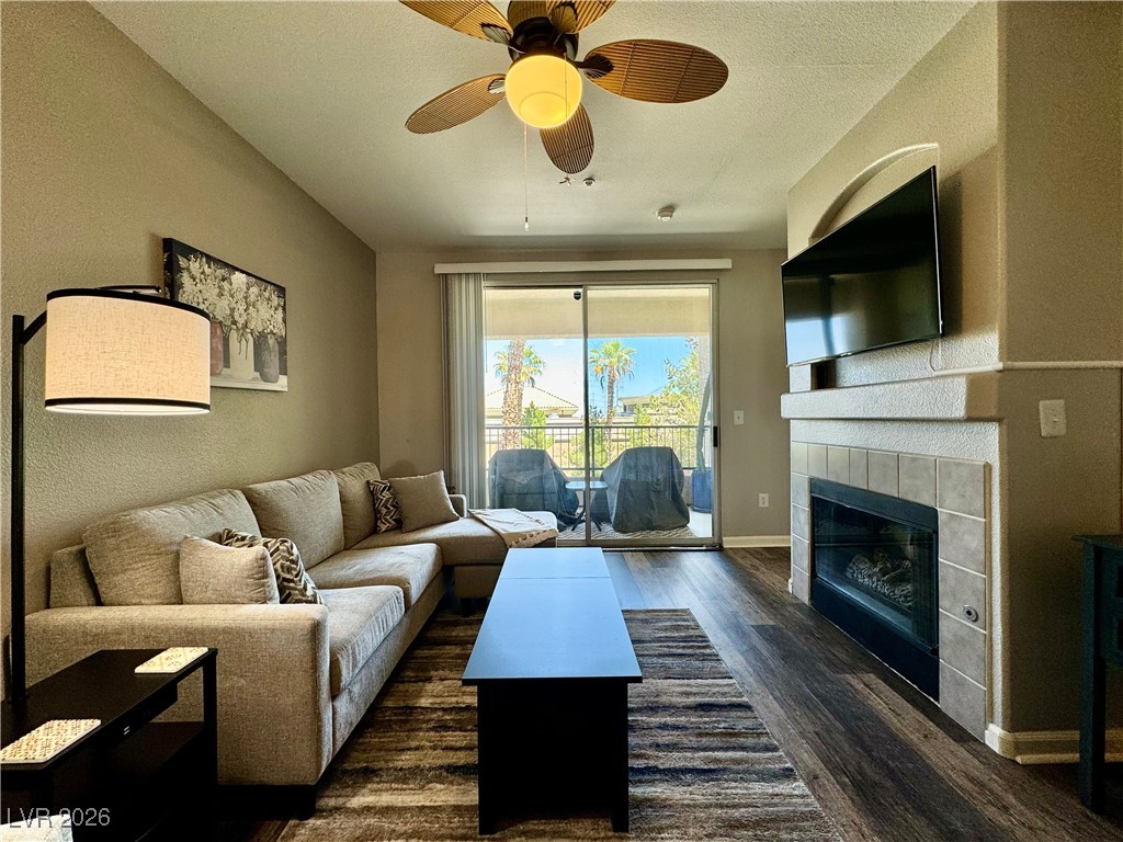 7151 South Durango Drive, Unit 307 Las Vegas, NV 89113 - Photo 9 of 17 Living Room featuring a Cozy Gas Fireplace and access to your private Balcony