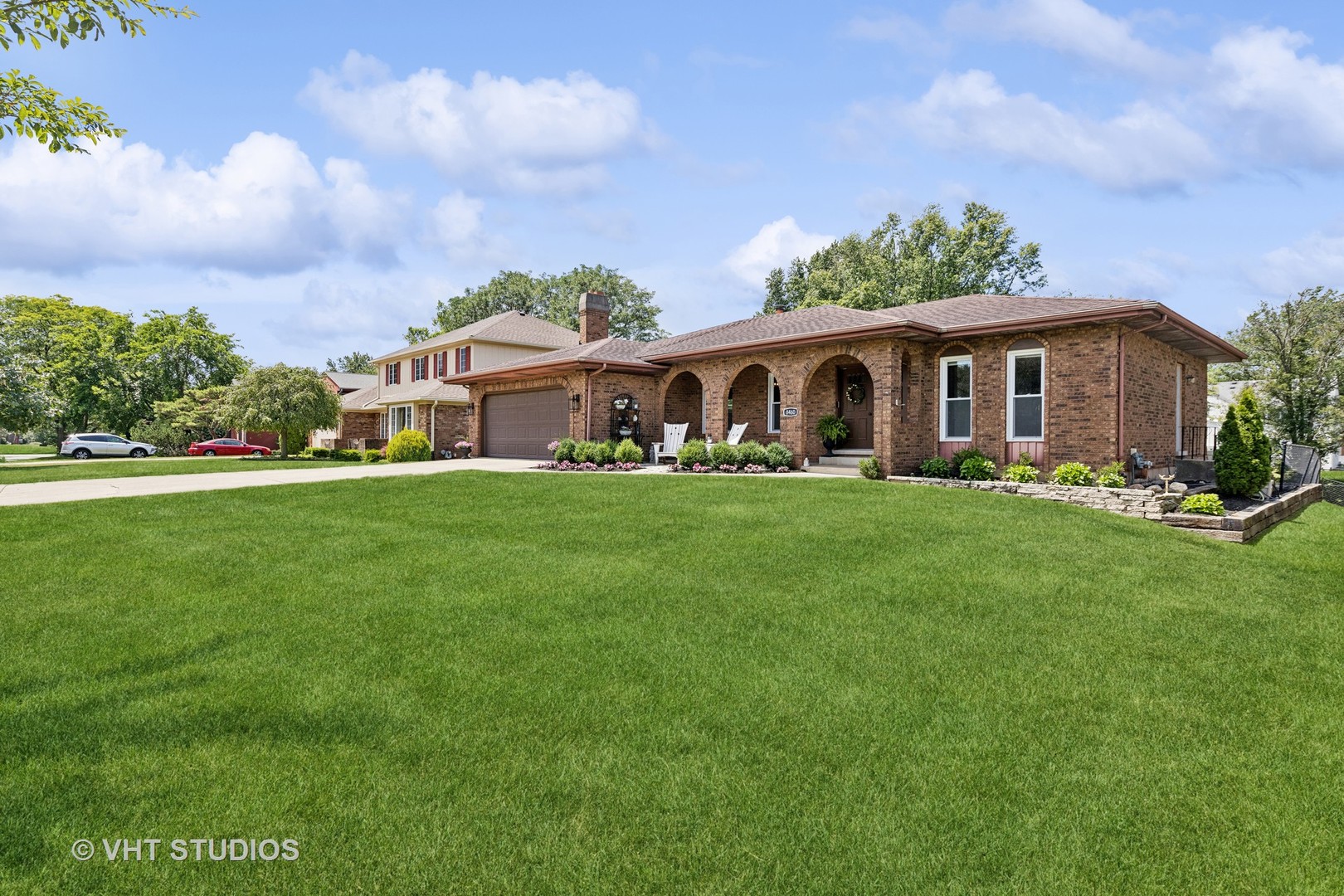 a front view of house with yard and green space