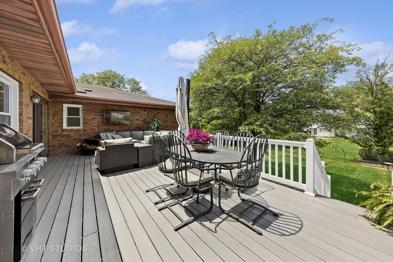 8460 Dolfor Cove Burr Ridge, IL 60527 - Photo 25 of 32 a view of a roof deck with table and chairs couches with wooden floor and fence