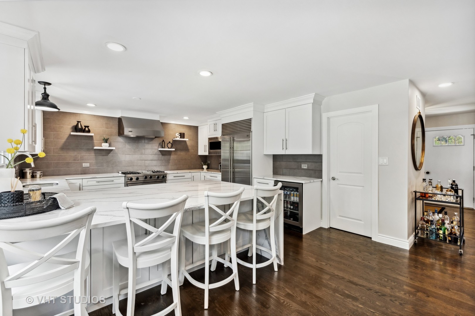 8460 Dolfor Cove Burr Ridge, IL 60527 - Photo 3 of 32 a kitchen with stainless steel appliances kitchen island granite countertop a table chairs sink and cabinets