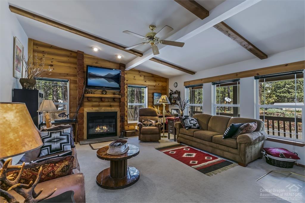 17171 Island Loop Way Bend, OR 97707 - Photo 4 of 25 a living room with furniture a fireplace and a large window