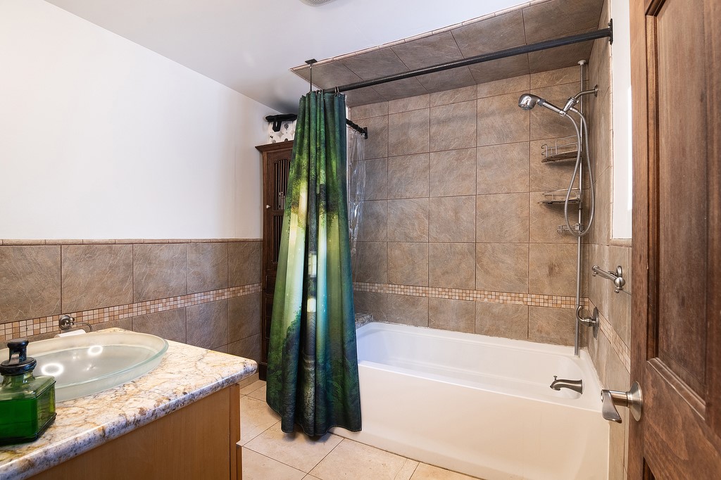 1935 Summit Avenue Pasadena, CA 91103 - Photo 12 of 27 a bathroom with a granite countertop bathtub shower and vanity