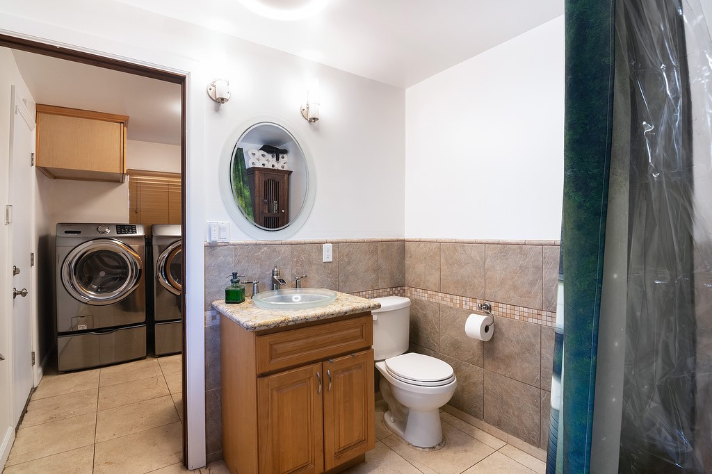 1935 Summit Avenue Pasadena, CA 91103 - Photo 13 of 27 a bathroom with a toilet a sink and mirror