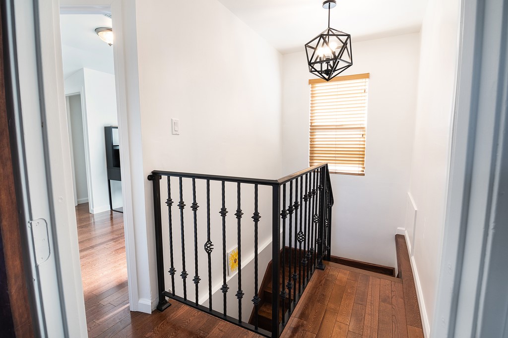 1935 Summit Avenue Pasadena, CA 91103 - Photo 16 of 27 a view of a hallway with wooden floor and a chandelier