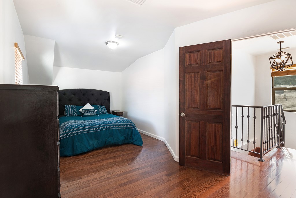 1935 Summit Avenue Pasadena, CA 91103 - Photo 17 of 27 a bedroom with a bed and wooden floor