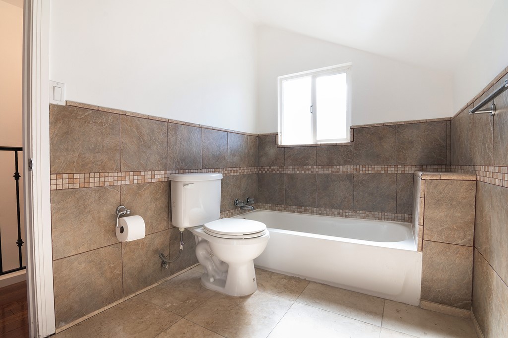 1935 Summit Avenue Pasadena, CA 91103 - Photo 18 of 27 a bathroom with a white toilet sitting next to a bathtub