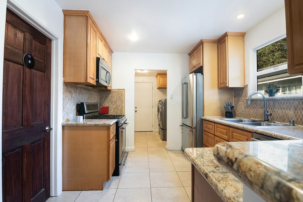 1935 Summit Avenue Pasadena, CA 91103 - Photo 6 of 27 a kitchen with stainless steel appliances granite countertop a refrigerator a stove top oven a sink and dishwasher