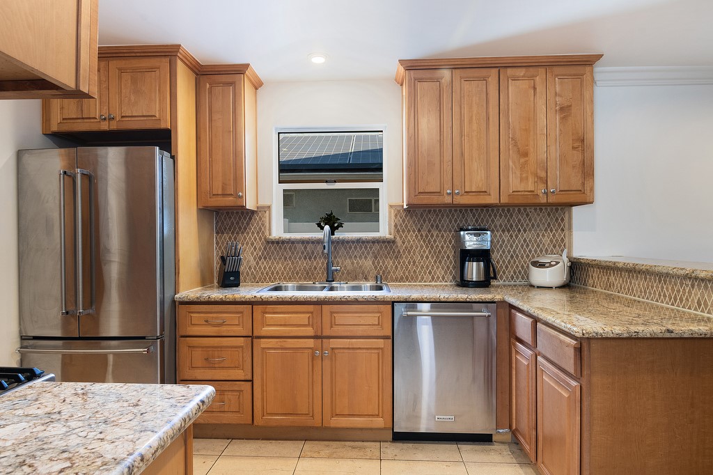 1935 Summit Avenue Pasadena, CA 91103 - Photo 8 of 27 a kitchen with stainless steel appliances granite countertop a sink stove refrigerator and cabinets
