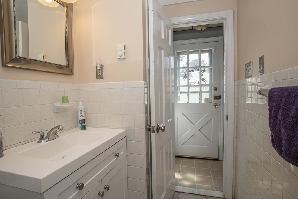 28 Augustine Street Brockton, MA 02301 - Photo 12 of 34 a bathroom with a sink a mirror and shower