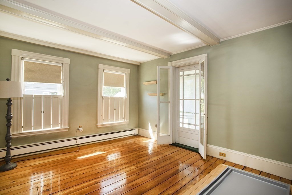 28 Augustine Street Brockton, MA 02301 - Photo 14 of 34 an empty room with wooden floor and windows