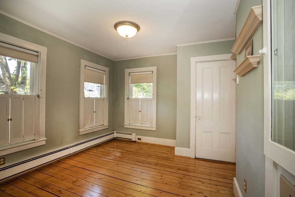 28 Augustine Street Brockton, MA 02301 - Photo 17 of 34 a view of an empty room with window and wooden floor