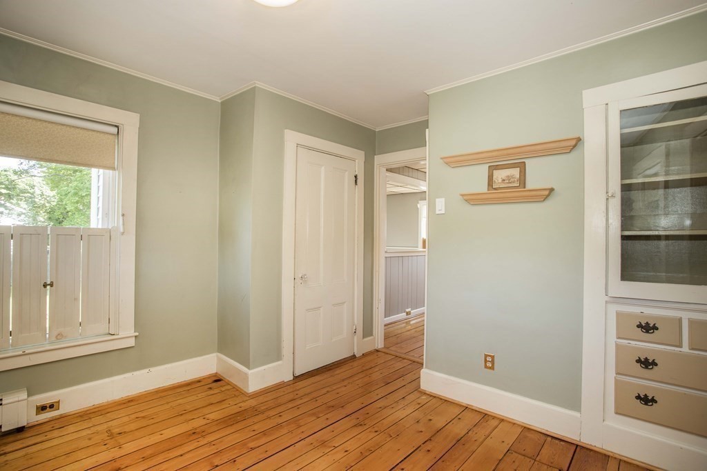 28 Augustine Street Brockton, MA 02301 - Photo 18 of 34 a view of an empty room with wooden floor and a window