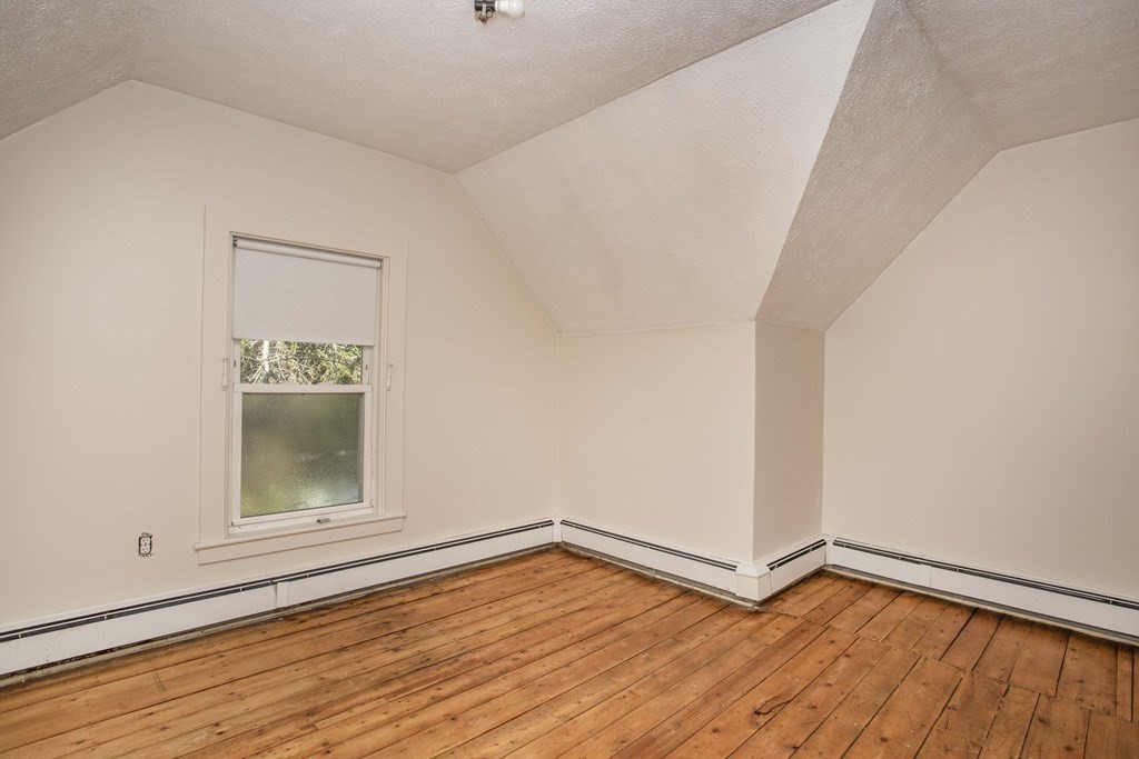 28 Augustine Street Brockton, MA 02301 - Photo 28 of 34 a view of an empty room with wooden floor and a window