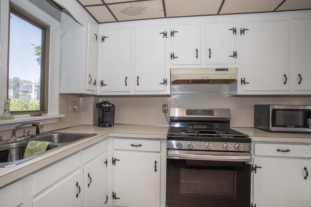 28 Augustine Street Brockton, MA 02301 - Photo 7 of 34 a kitchen with cabinets appliances and a sink
