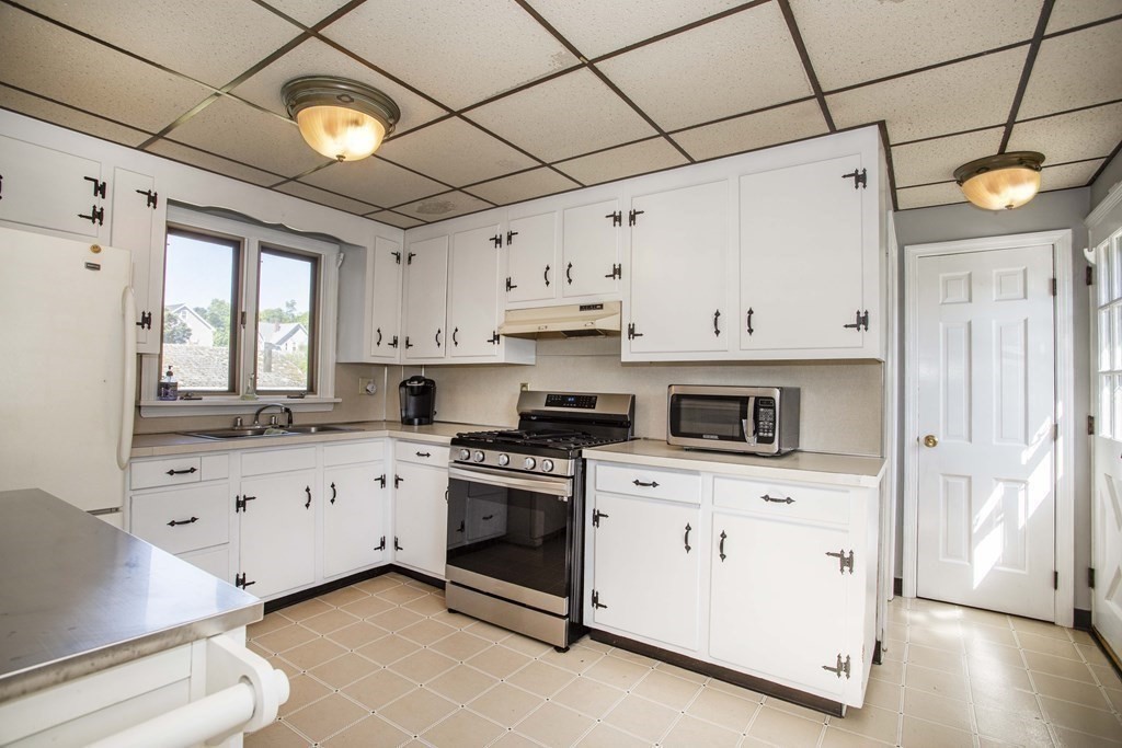 28 Augustine Street Brockton, MA 02301 - Photo 8 of 34 a kitchen with cabinets stainless steel appliances and wooden floor