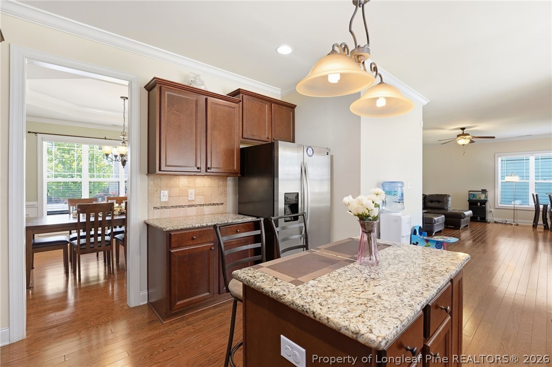 886 Micahs Way North Spring Lake, NC 28390 - Photo 8 of 50 a kitchen with a table chairs and wooden floor