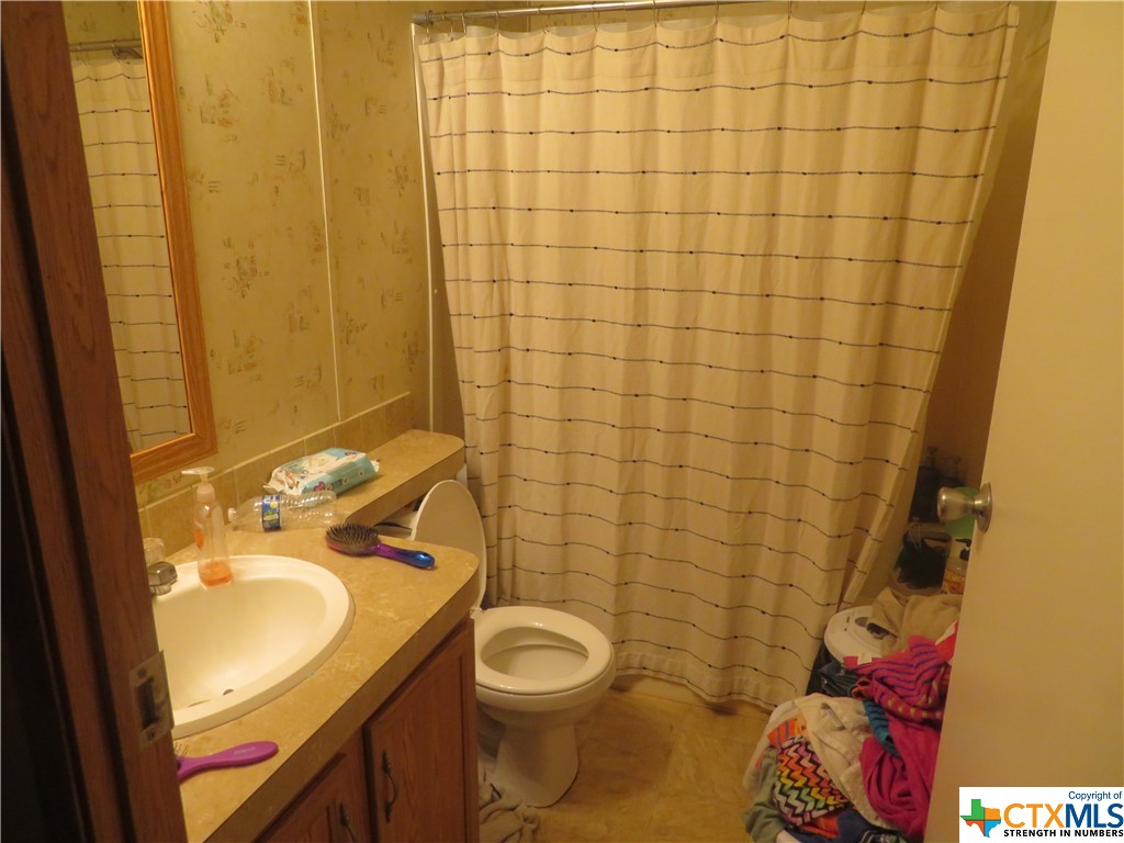 191 Refugio Street La Ward, TX 77970 - Photo 6 of 7 a bathroom with a sink toilet and shower