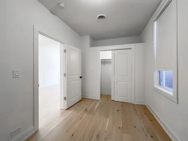 a view of hallway with wooden floor