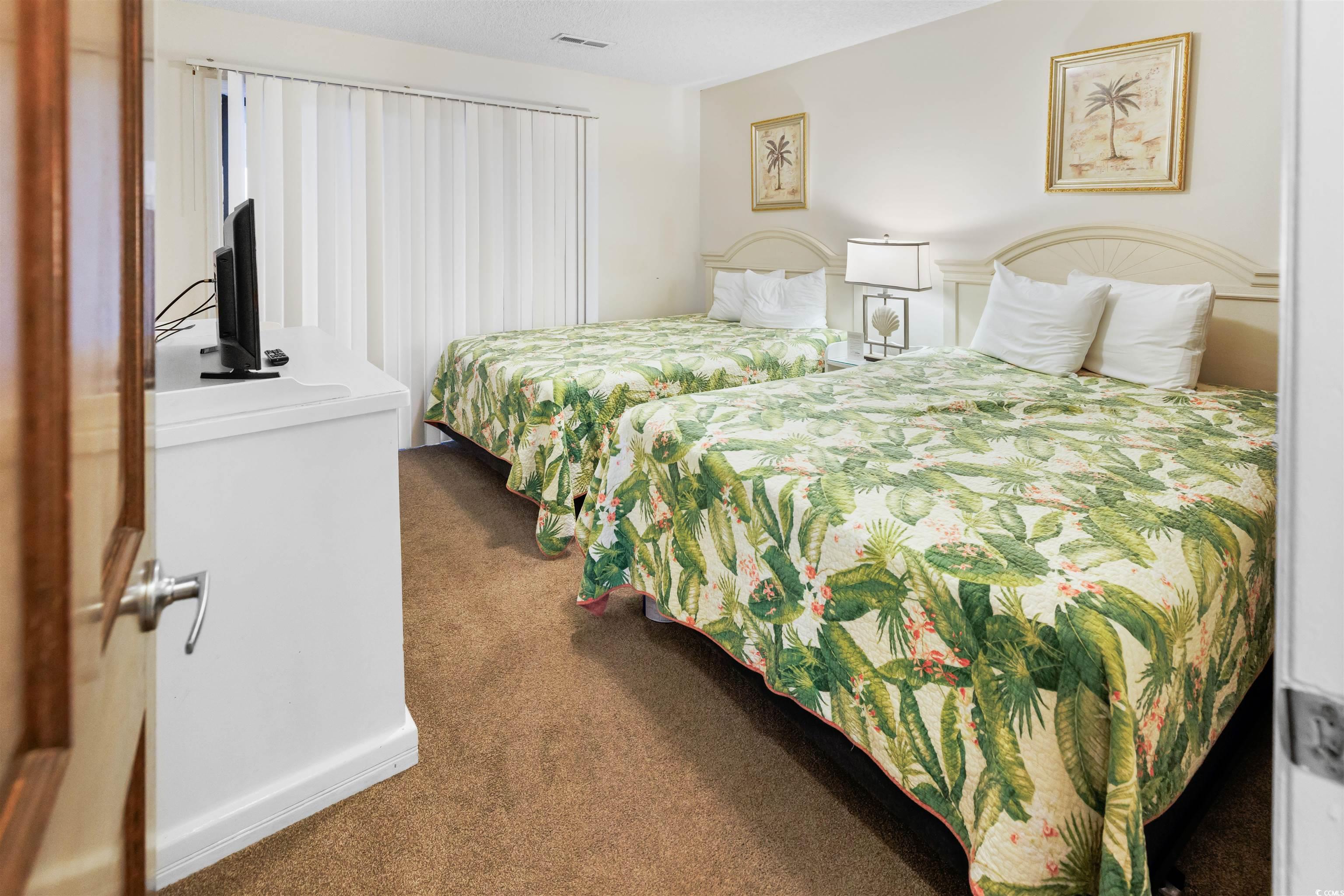 320 North Waccamaw Drive, Unit 3B Murrells Inlet, SC 29576 - Photo 10 of 15 Bedroom featuring dark colored carpet