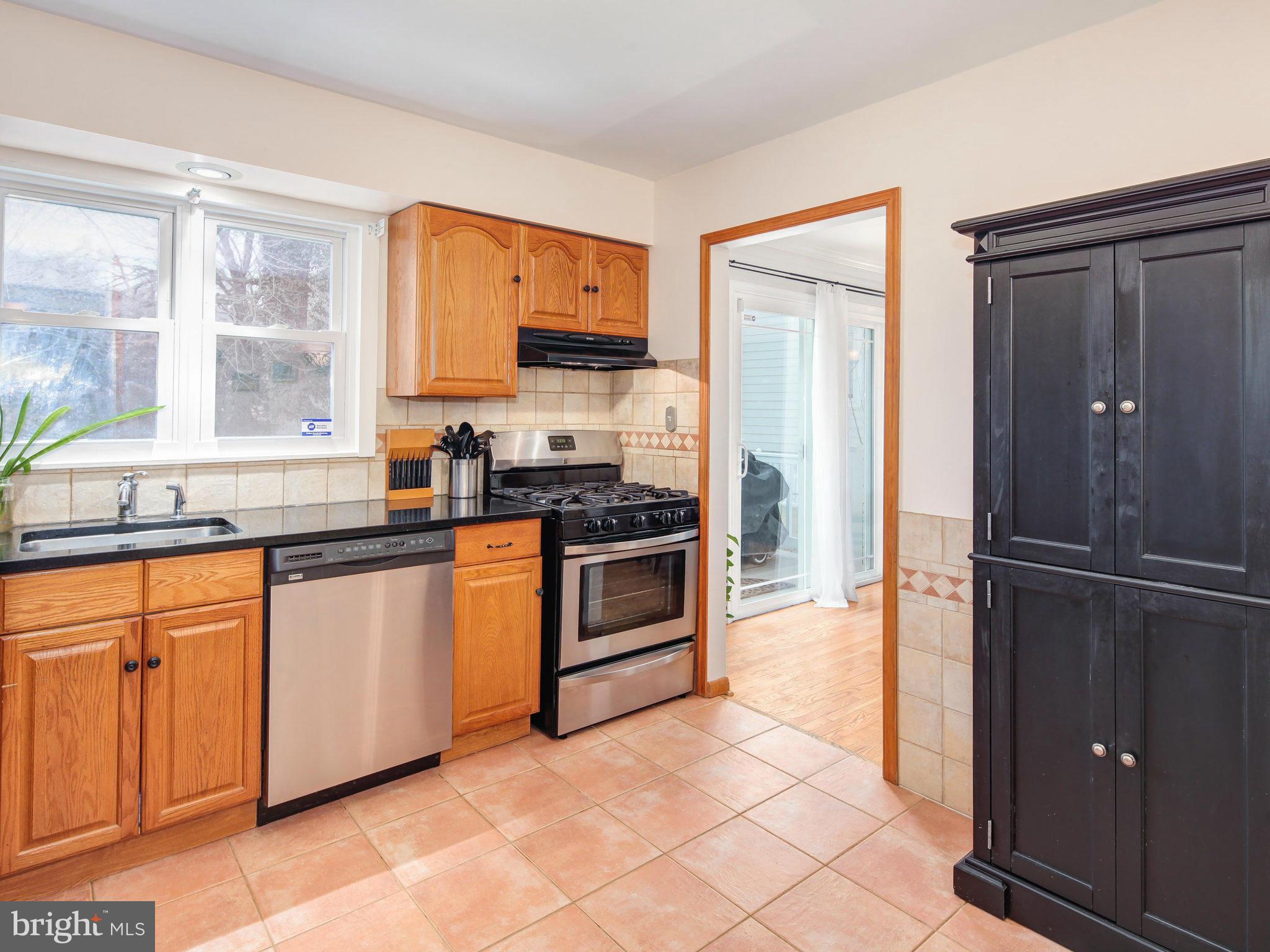 5808 Greentree Road Bethesda, MD 20817 - Photo 8 of 26 a kitchen with stainless steel appliances granite countertop a refrigerator and a sink