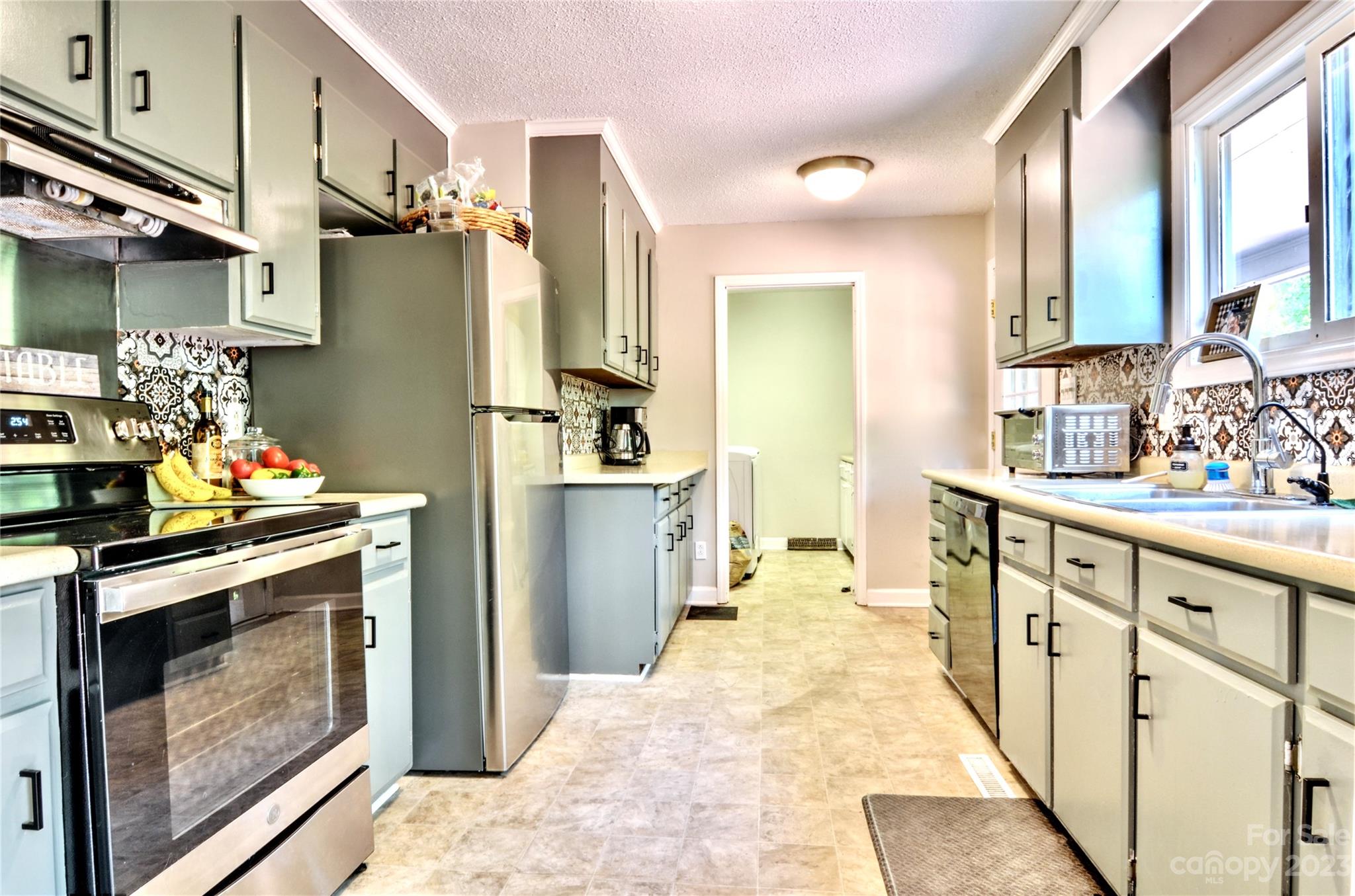2605 Bob White Circle Wingate, NC 28174 - Photo 10 of 25 a kitchen with stainless steel appliances a stove and a refrigerator