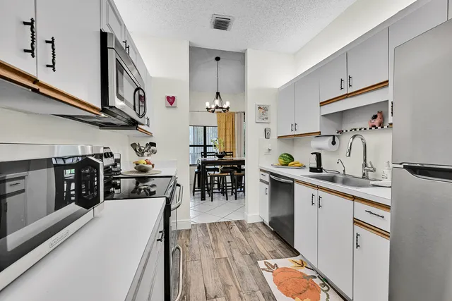 a bedroom with a bed lamps and dresser