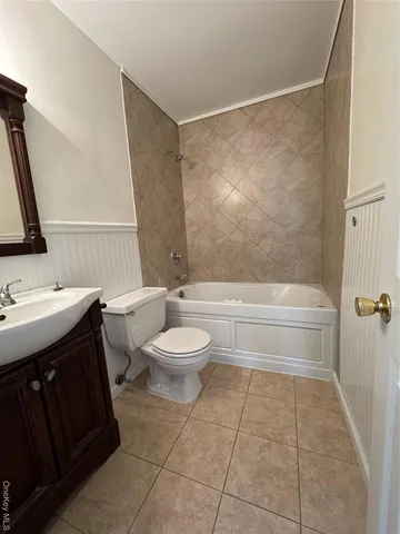 a bathroom with a toilet a sink and bathtub