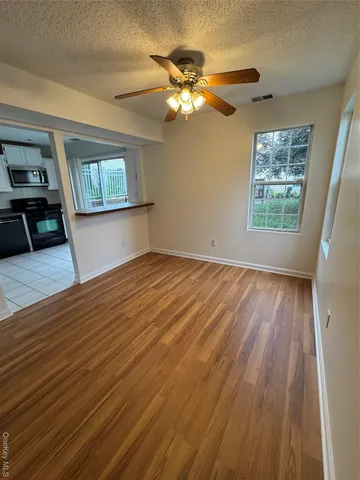 wooden floor in an empty room with a window