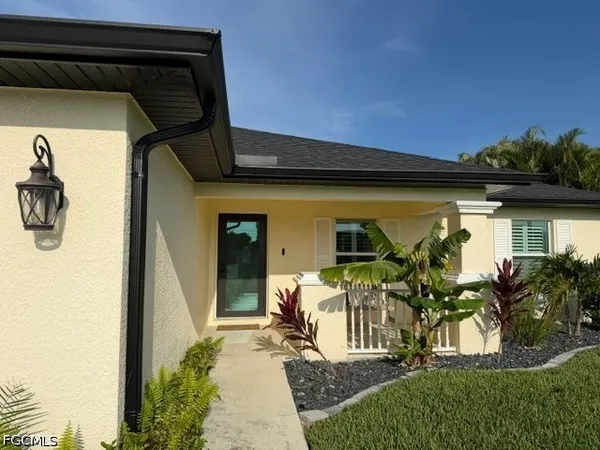 a front view of a house with a garden