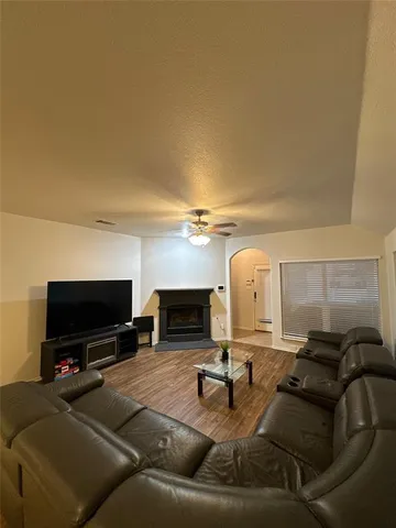 a living room with furniture and a fireplace