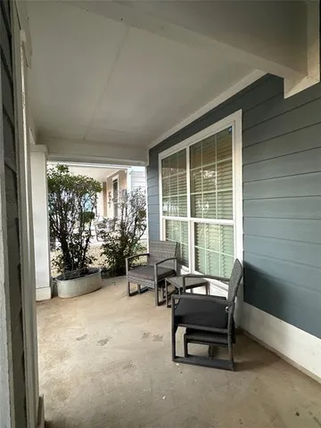 a living room with furniture and floor to ceiling window