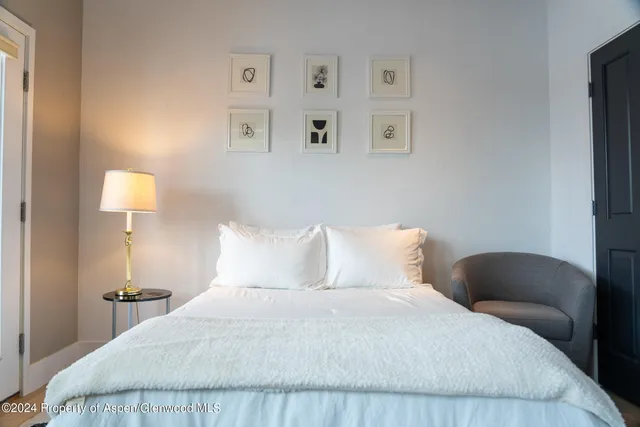 a bedroom with a bed and lamp