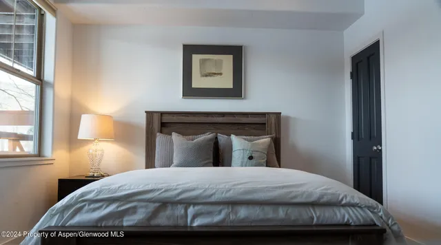 a bedroom with a bed and window