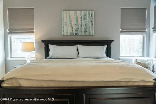 a bedroom with a bed and window