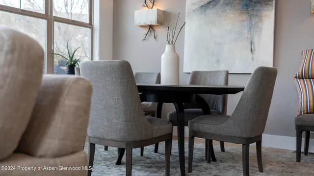 a view of a dining room with furniture and a window