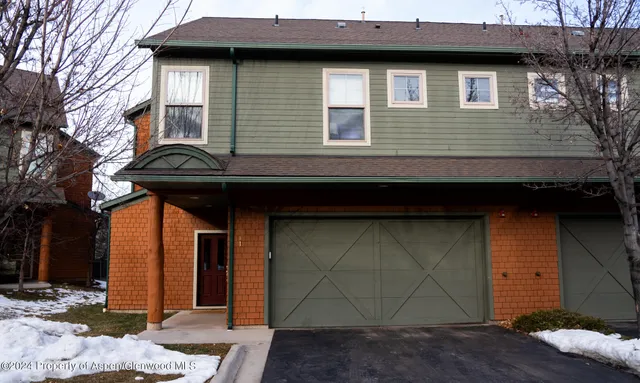 a view of a house with wooden fence