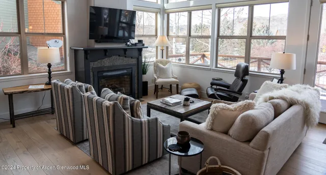 a living room with furniture fireplace and flat screen tv